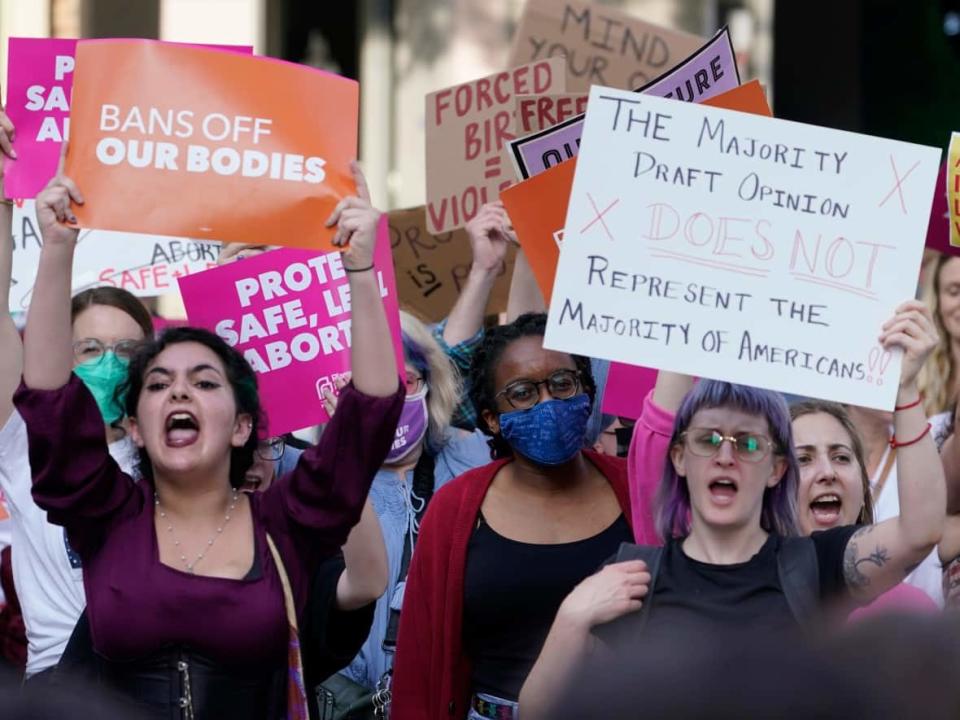 Protesters demonstrate near a federal court in Richmond, Va., on Tuesday. A leaked Supreme Court draft opinion that would throw out the landmark Roe v. Wade abortion rights ruling had Americans grappling with what might come next. (Steve Helber/The Associated Press - image credit)