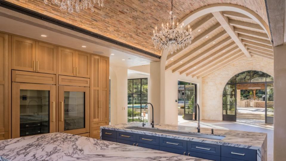 The main kitchen has barrel-vaulted brick ceilings with custom-made chandeliers. - Credit: Paul Rollins