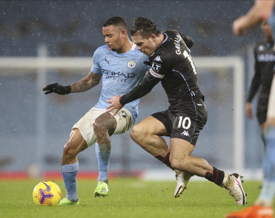 Aston Villa's Jack Grealish, right, and Manchester City's Gabriel Jesus challenge for the ball during the English Premier League soccer match between Manchester City and Aston Villa at the Etihad Stadium in Manchester, England, Wednesday, Jan.20, 2021. (Clive Brunskill/Pool via AP)