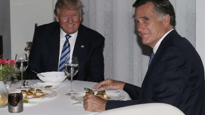 Donald Trump sits at a meal around the table with Mitt Romney