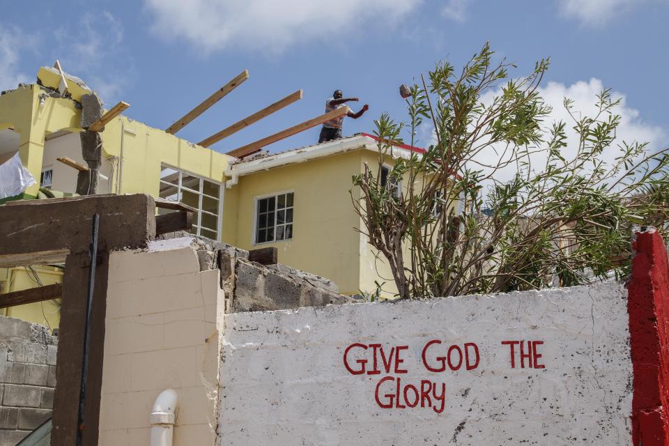 A man removes debris from his home, which was destroyed by Hurricane Beryl in Clifton, Union Island, St. Vincent and the Grenadines, Thursday, July 4, 2024. (AP Photo/Lucanus Ollivierre)