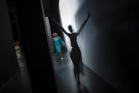 <p>In this slow shutter speed picture, a model enters the backstage area after displaying a 2017 spring/summer design by Maria Escote during Madrid’s Fashion Week, Sept. 18, 2016.(Photo: Daniel Ochoa de Olza/AP) </p>