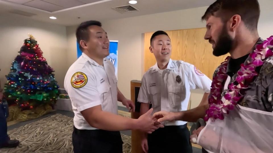 PHOTO:  Ian Snyder, 34, meets on Dec. 12, 2023, some of the Honolulu EMS paramedics who helped rescue him after he survived a 1,000-foot fall from a hiking trail in Hawaii. (KITV)
