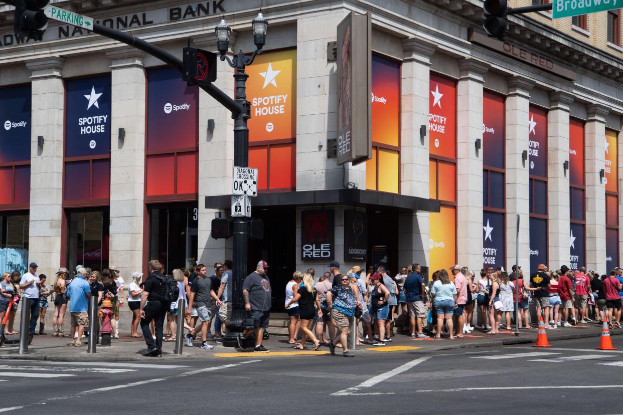 A large line surrounds Spotify House during the CMA Fest in Nashville, Tenn., Sunday, June 12, 2022. 