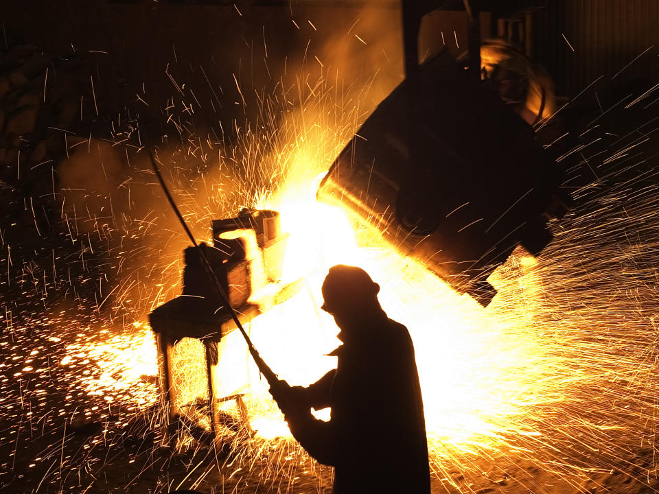 A man standing in front of a sparking steel