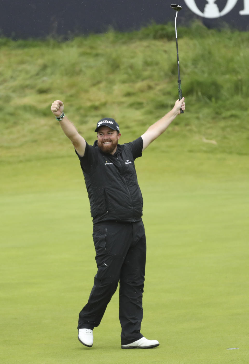 Ireland's Shane Lowry lifts his club to celebrate as he wins the British Open Golf Championships at Royal Portrush in Northern Ireland, Sunday, July 21, 2019.(AP Photo/Peter Morrison)