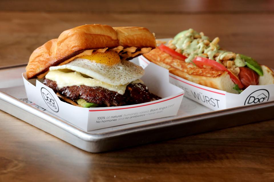 A burger called "The Little Mule" and a hot dog called "Sooo Cali" at the new Dog Haus Biergarten in Mohegan Lake, photographed Dec. 8 2021.