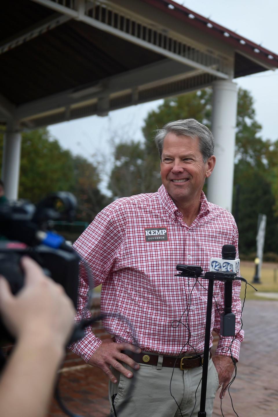 Georgia Governor Brian Kemp takes questions from the media after a campaign stop in Evans Towne Center Park on Saturday, Nov. 5, 2022. Kemp met with voters and encouraged people to turn out to the polls next week. 