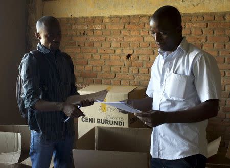 Officials of Burundi's National Electoral Commission take stock of electoral material for the upcoming parliamentary elections at a warehouse in the neighbourhood of Nyakabiga near the capital Bujumbura, June 28, 2015. REUTERS/Paulo Nunes dos Santos