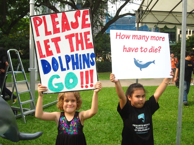 Event supporters were invited to pose for pictures with placards bearing messages in support of the dolphins. (Yahoo! photo/Jeanette Tan)