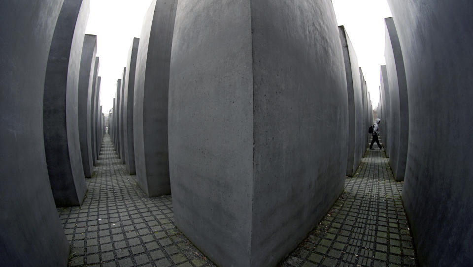 File - In this Monday, Jan. 20, 2020 fill photo a man visits the Holocaust Memorial in Berlin, Germany. The memorial to the Jewish victims of the Holocaust with a total of 2711 concrete slabs designed by U.S. architect Peter Eisenman was inaugurated on May 10, 2005. A new report documenting anti-Semitism in Berlin reveals that little progress has been made in combatting the problem in the German capital. The Department for Research and Information on Anti-Semitism Berlin, or RIAS documented 410 incidents in Berlin, more than two a day, in the first half of 2020, including physical attacks, property damage, threats, harmful behavior and anti-Semitic propaganda. (AP Photo/Michael Sohn, file)