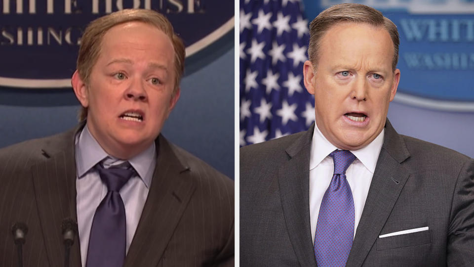 Melissa McCarthy with a receding hairline wearing a suit and blue tie side by side with Sean Spicer in the same outfit