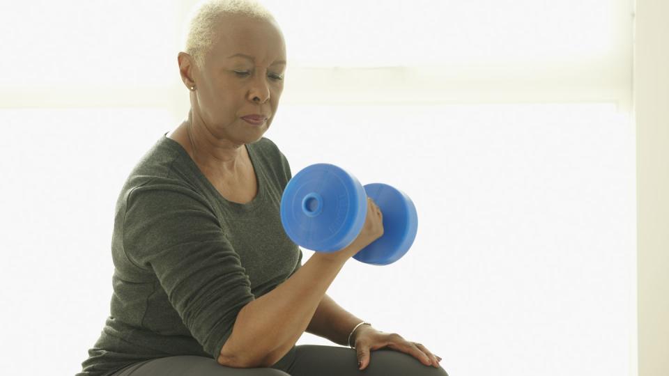 black woman lifting weights