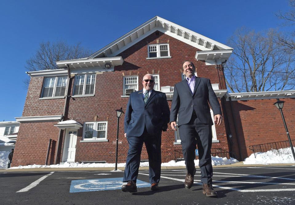 James Scott, at left, and Garrett S. Shames walk outside the W. James Scott Jr Funeral Home in Erie on Jan. 21. Shames is assisting Scott on the leasing or reusing of the now-vacant funeral home.