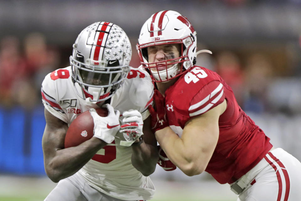 Ohio State wide receiver Binjimen Victor (9) is tackled by Wisconsin linebacker Leo Chenal (45) during the second half of the Big Ten championship NCAA college football game Saturday, Dec. 7, 2019, in Indianapolis. (AP Photo/Michael Conroy)