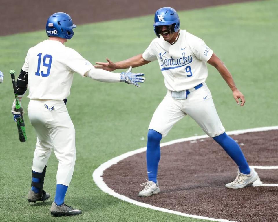 Nick Lopez (9) celebrates his eighth home run of the season with teammate Nolan McCarthy after crossing home plate in the third inning to extend UK’s lead to 3-0