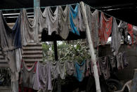 <p>Clothes covered with ash hang on washing lines outside a house affected by the eruption of the Fuego volcano at San Miguel Los Lotes in Escuintla, Guatemala, June 7, 2018. (Photo: Carlos Jasso/Reuters) </p>