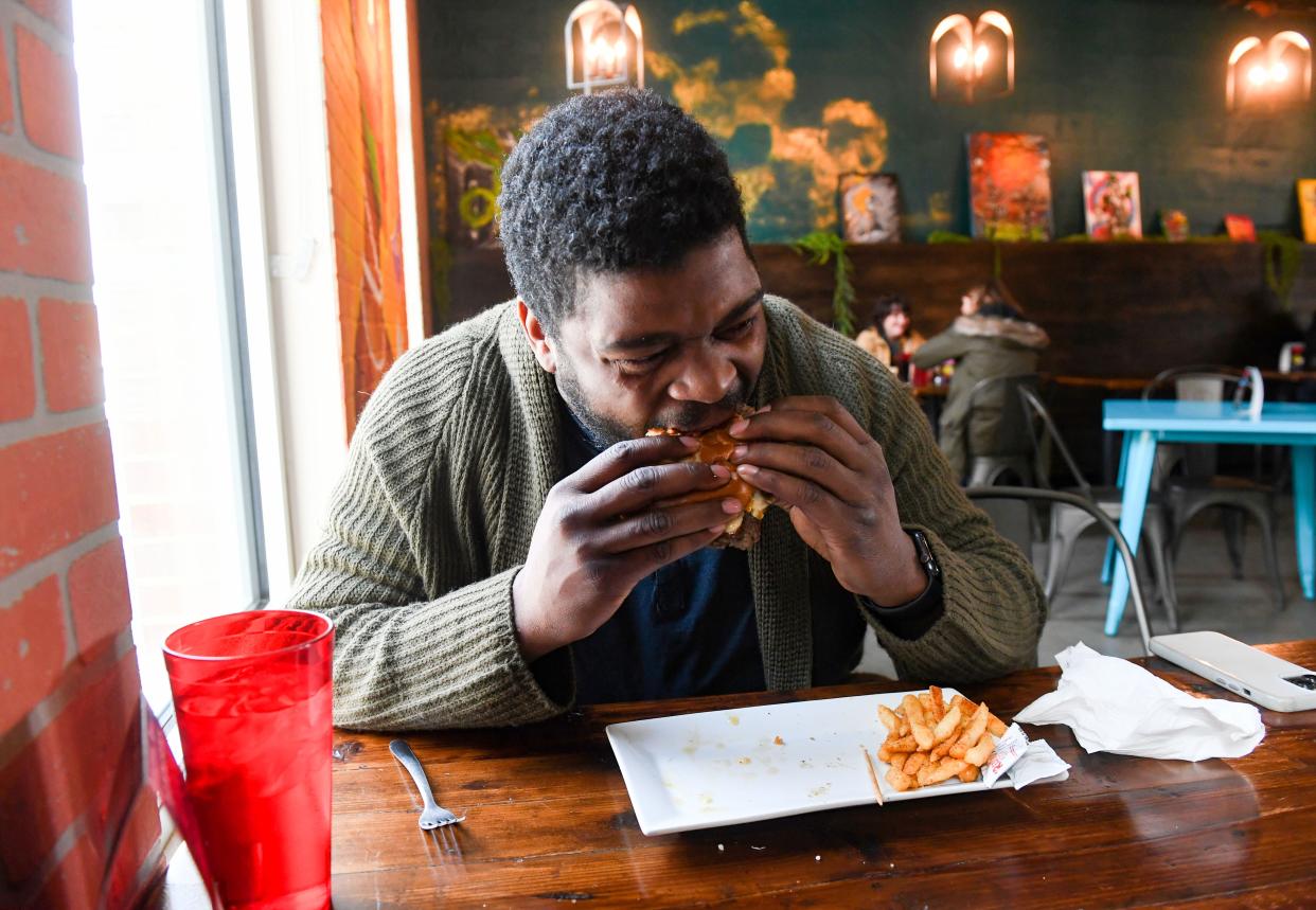 Langston Newton eats his final burger to try all 32 from the Downtown Burger Battle on Saturday, January 21, 2023, Swamp Daddy’s in Sioux Falls.