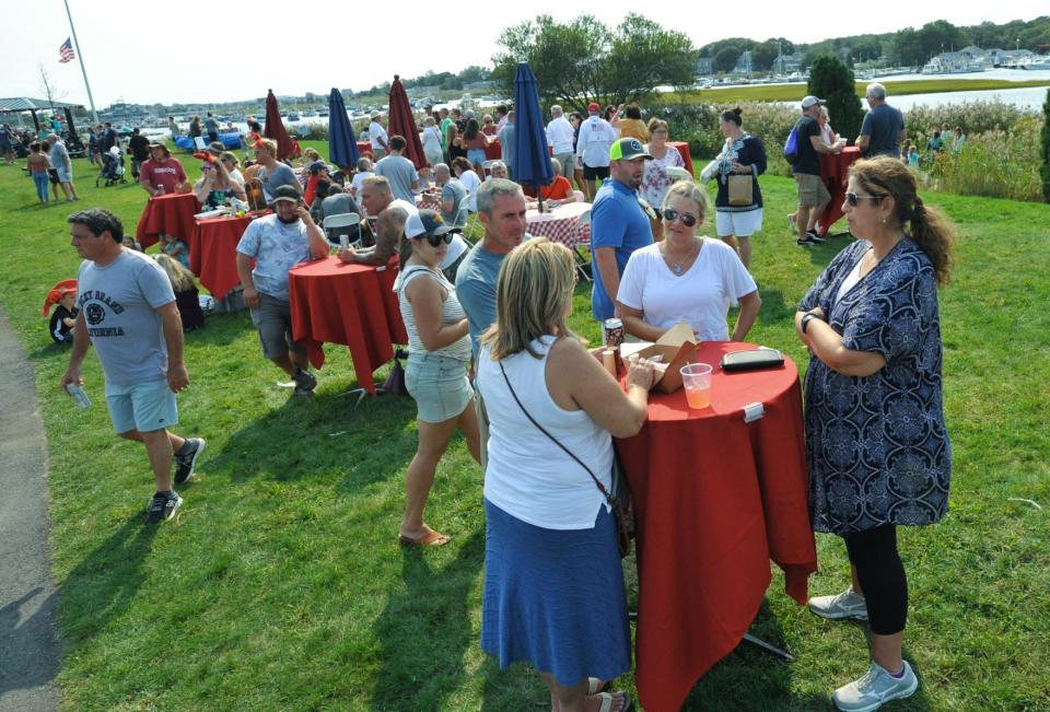 Festivalgoers enjoy food and conversation at the Marshfield LobsterFest at Harbor Park, Sunday, Sept. 12, 2021.