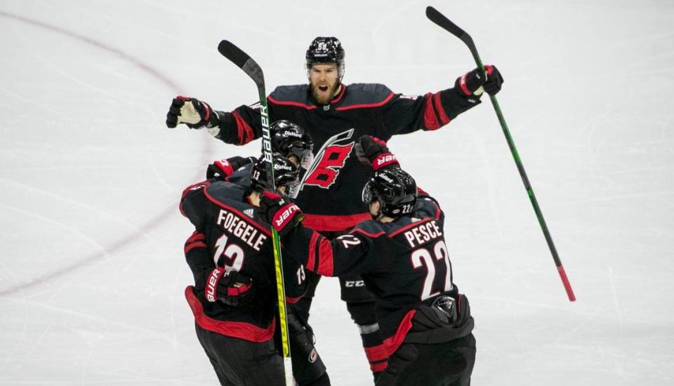 Carolina Hurricanes’ Jordan Staal (11) is surrounded by teammates after scoring in the third period to give the Hurricanes a 4-2 lead during their first round Stanley Cup series game against Nashville on Monday, May 17, 2021 at PNC Arena in Raleigh, N.C