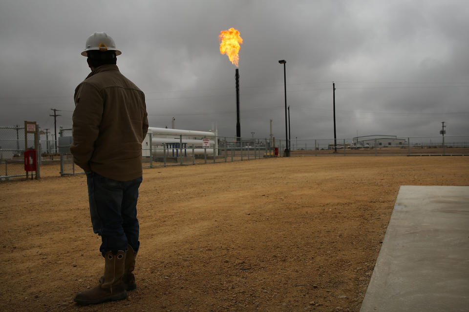 Flared natural gas is burned off at Apache Corporations' operations at the Deadwood natural gas plant in the Permian Basin, Garden City, Texas. To meet climate pledges, fossil fuel production must drop by 6% a year for the next decade. (Photo: Spencer Platt via Getty Images)