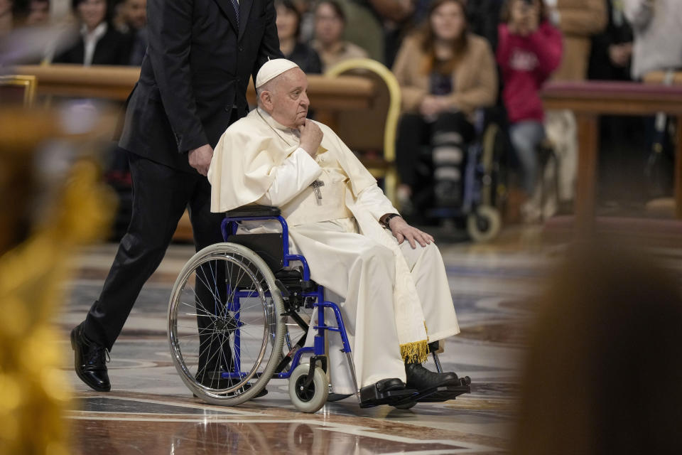 FILE - Pope Francis arrives to preside over a Mass in St. Peter Basilica at the Vatican, Sunday, Nov. 19, 2023. Pope Francis cancelled his trip to Dubai for the U.N. climate conference on doctors’ orders. The announcement marked the second time the pope’s frail health had forced the cancellation of a foreign trip: He had to postpone a planned trip to Congo and South Sudan in 2022 because of knee inflammation, though he was able to make the trip earlier this year. (AP Photo/Andrew Medichini, File)