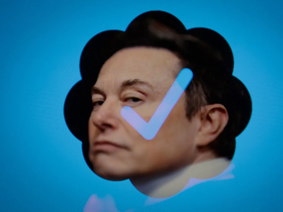 Elon Musk's face with a blue tick on a blue background.