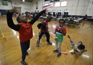 In this June 13, 2019 photo, migrant children play inside the Portland Exposition Building in Portland, Maine. Maine's largest city has repurposed the basketball arena as an emergency shelter in anticipation of hundreds of asylum seekers who are headed to the state from the U.S. southern border. Most are arriving from Congo and Angola. (AP Photo/Elise Amendola)