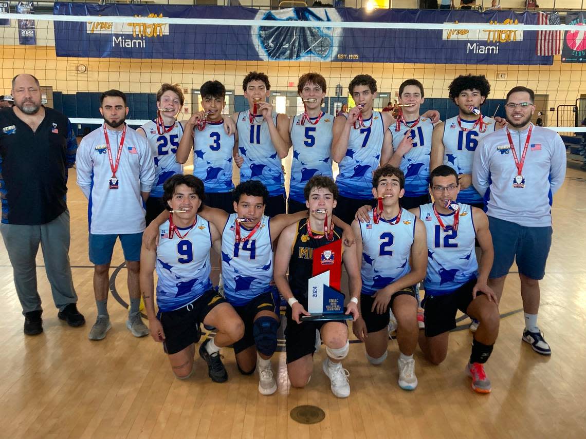 Miami High players and coaches pose with the GMAC boys volleyball championship trophy after beating Southwest in the final at its home gym on Friday night.