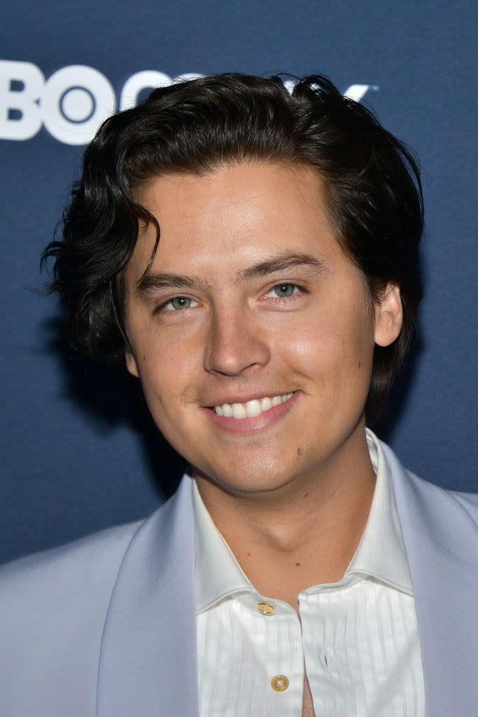 Cole Sprouse smiling at an event