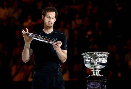 Britain's Andy Murray looks at the runner-up plate as he walks past the men's singles trophy after losing his final match against Serbia's Novak Djokovic at the Australian Open tennis tournament at Melbourne Park, Australia, January 31, 2016. REUTERS/Thomas Peter