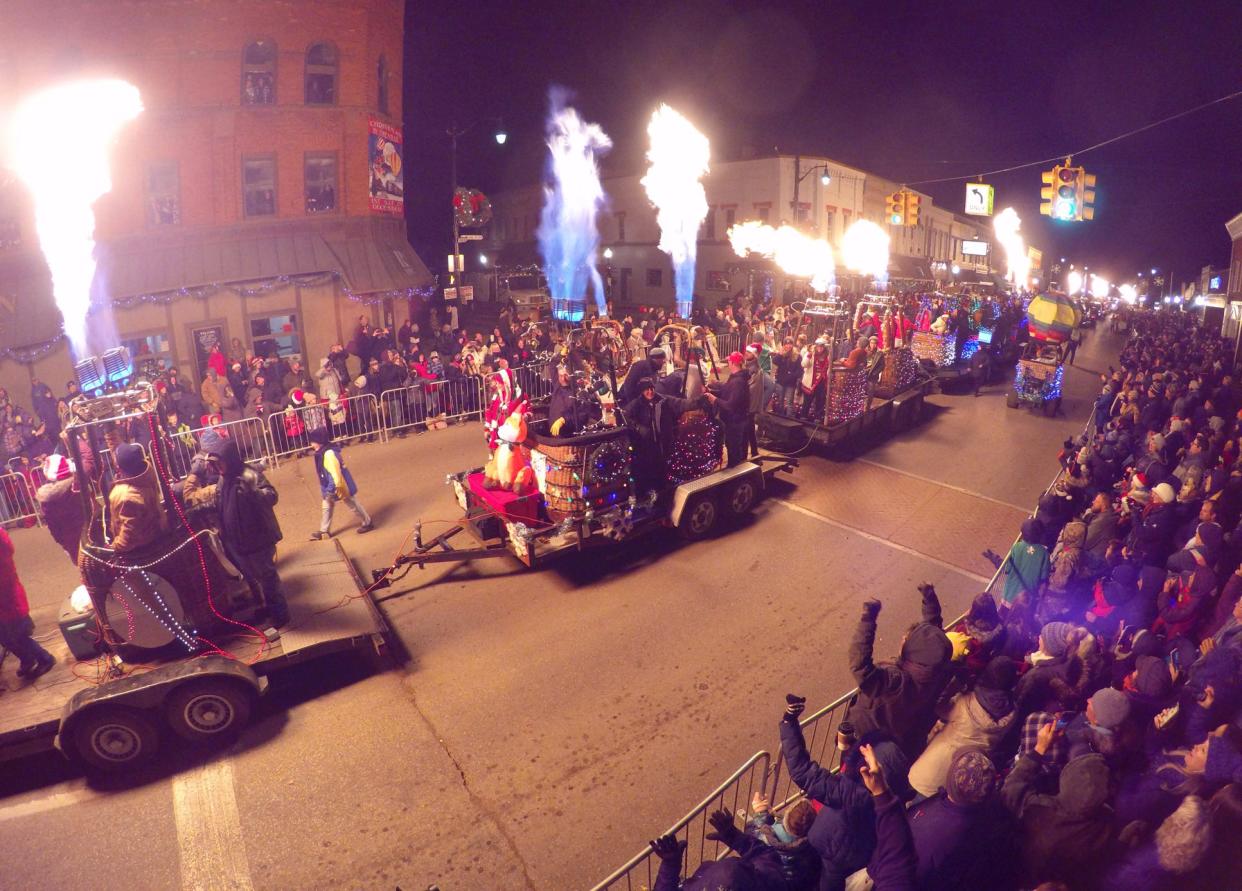 A line of hot-air balloon baskets with their torches burning light up Grand River Avenue in downtown Fowlerville Saturday, Dec. 7, 2019 near the end of the  Christmas in the ‘Ville parade.