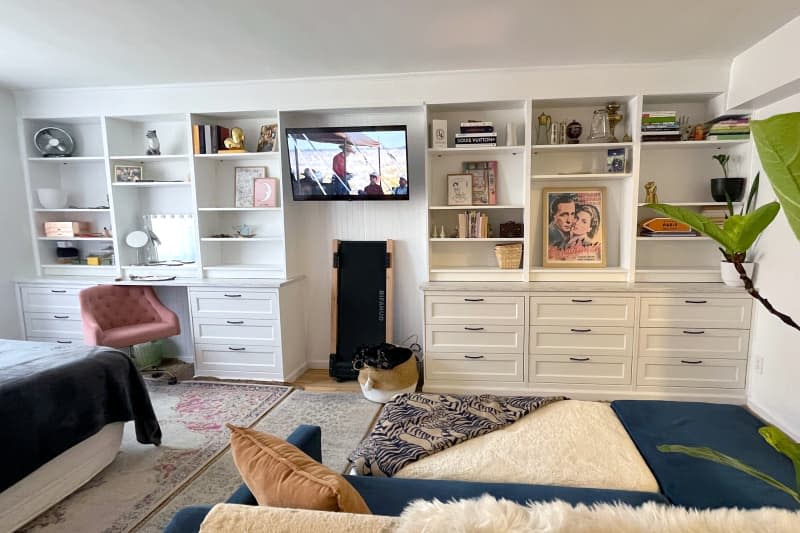 White shelving and drawers line wall, replacing etageres and various shelving pieces.