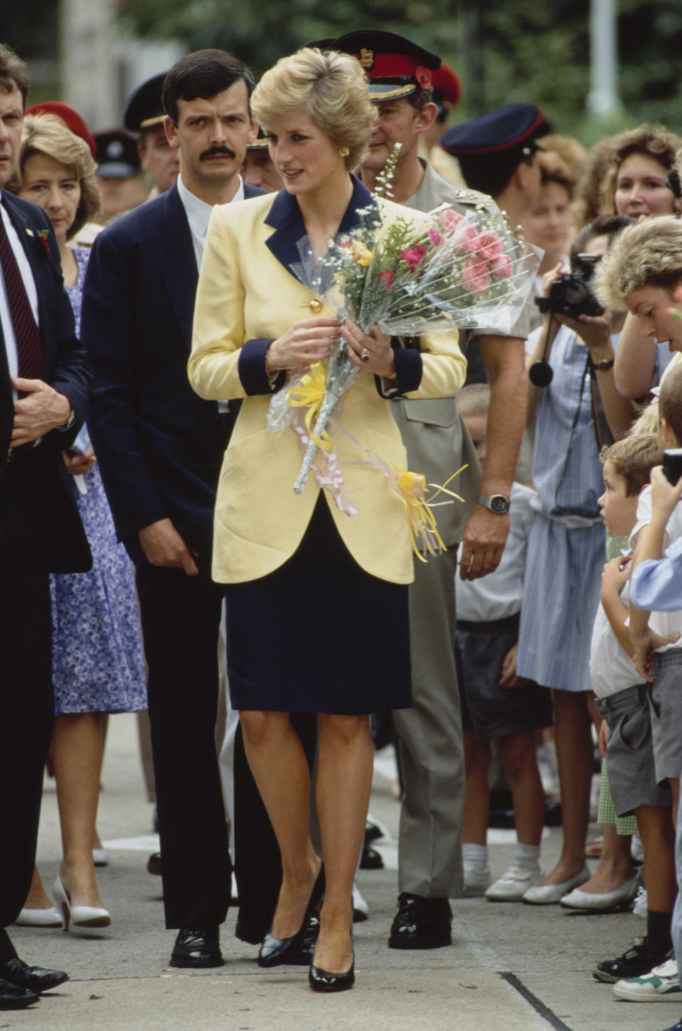 British Royal Diana, Princess of Wales (1961-1997), wearing a yellow-and-navy blue Catherine Walker suit with gold buttons, during a visit to Tamar, a British Forces shore base in Hong Kong, 8th November 1989. Diana and her husband Charles are on a three-day visit to Hong Kong. (Photo by Tim Graham Photo Library via Getty Images)