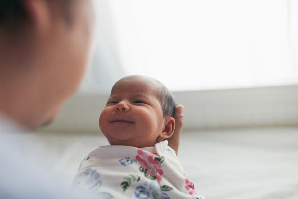 A parent is holding their newborn baby