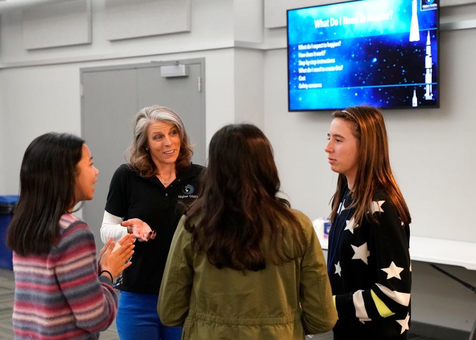 Michelle Lucas, second from left, founder and president of Higher Orbits, speaks with, from left, Abby Nguyen and Ariya Sinha, both from Bloomfield Hills, and Kate Phelps, right, from Birmingham, all Oakland County eighth graders, about producing oxygen and carbon dioxide in space during Friday's opening day of the two-day space exploration camp Go For Launch! Lenawee, which was open to eighth through 12th grade students and was at the Lenawee Intermediate School District Tech Center.