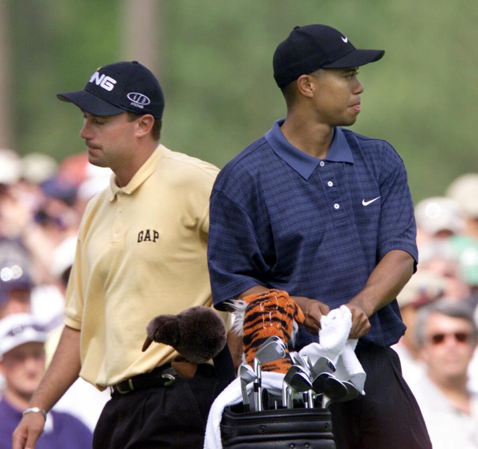 Chris DiMarco passes Tiger Woods as they get ready to tee up on the 12th hole in round 3 of the 2001 Masters Tournament at the Augusta National Golf Club. Mandatory Credit: Eileen Blass/USA