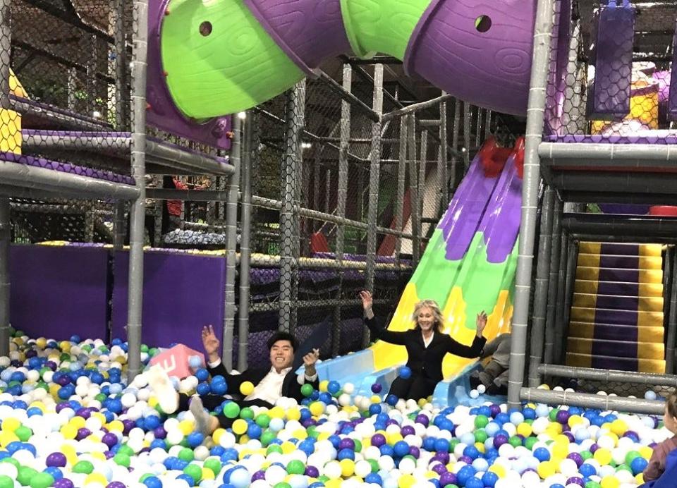 Taunton Mayor Shaunna O'Connell, right, and Fun City co-manager Ethan Zhang enjoy a ride on a ball slide following a grand opening ceremony on Jan. 10, 2023.