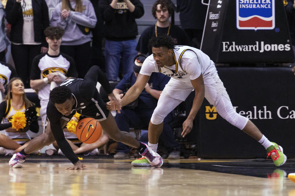 Mississippi State's Dashawn Davis, left, and Missouri's DeAndre Gholston scramble for the ball during the first half of an NCAA college basketball game Tuesday, Feb. 21, 2023, in Columbia, Mo. (AP Photo/L.G. Patterson)