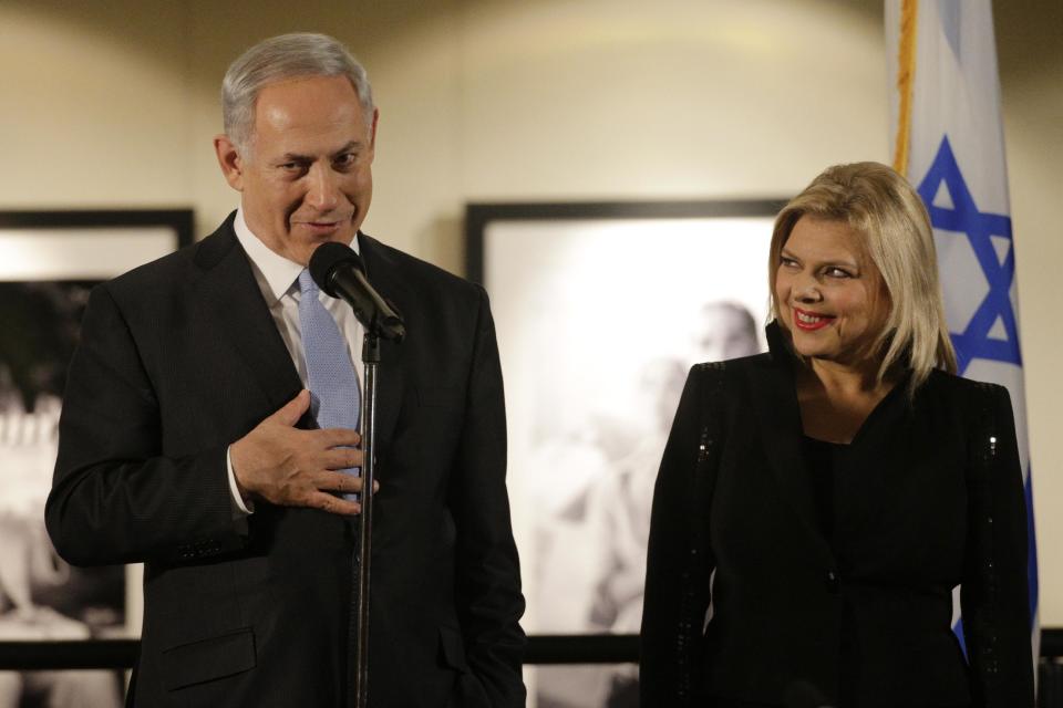 CORRECTS DAY AND DATE - Israeli Prime Minister Benjamin Netanyahu, accompanied by his wife Sara, right, speaks before the screening of the television documentary "Israel: The Royal Tour" at Paramount Studios on Tuesday, March 4, 2014, in Los Angeles. Netanyahu flew Tuesday from Washington, D.C., to California, trading a focus on the geopolitics of the Middle East for a Hollywood screening and visits with Silicon Valley tech entrepreneurs. (AP Photo/Jae C. Hong)