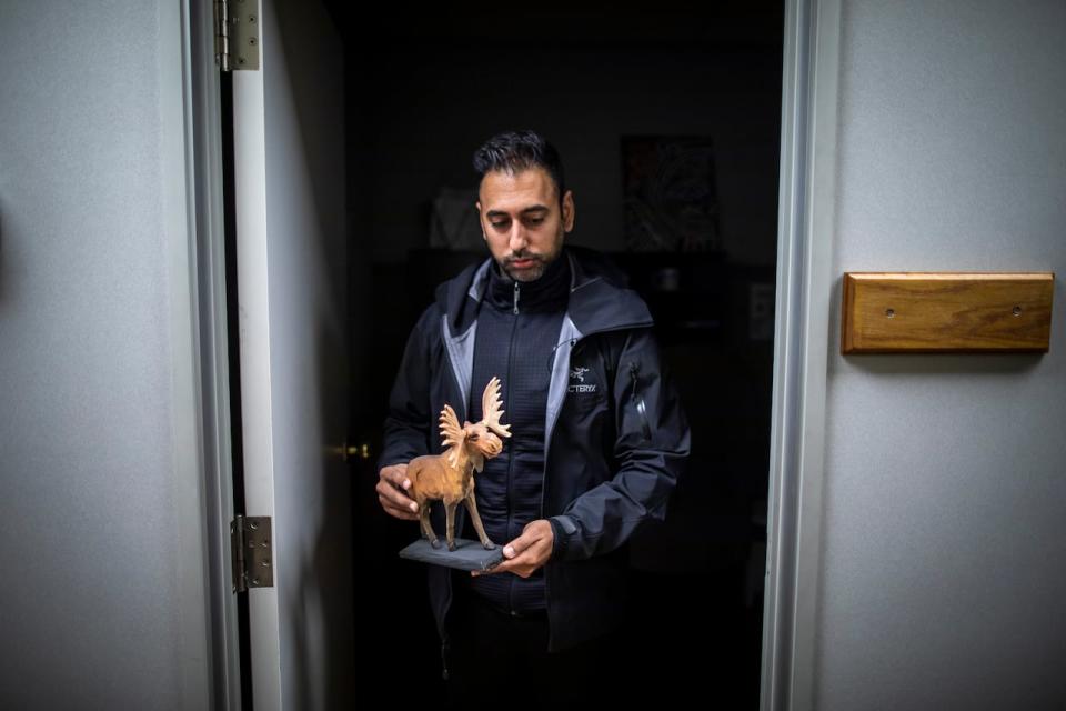 Dr. Aseem Grover is pictured with a piece of artwork a former patient gifted to him at the Fraser Canyon Clinic in downtown Hope, British Columbia on Wednesday, Jan. 31, 2024. 