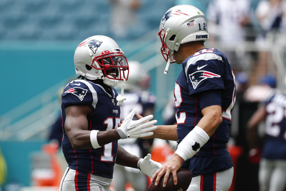 New England Patriots quarterback Tom Brady (12) greets wide receiver Antonio Brown (17) before the start of an NFL football game against the Miami Dolphins, Sunday, Sept. 15, 2019, in Miami Gardens, Fla. (AP Photo/Brynn Anderson)