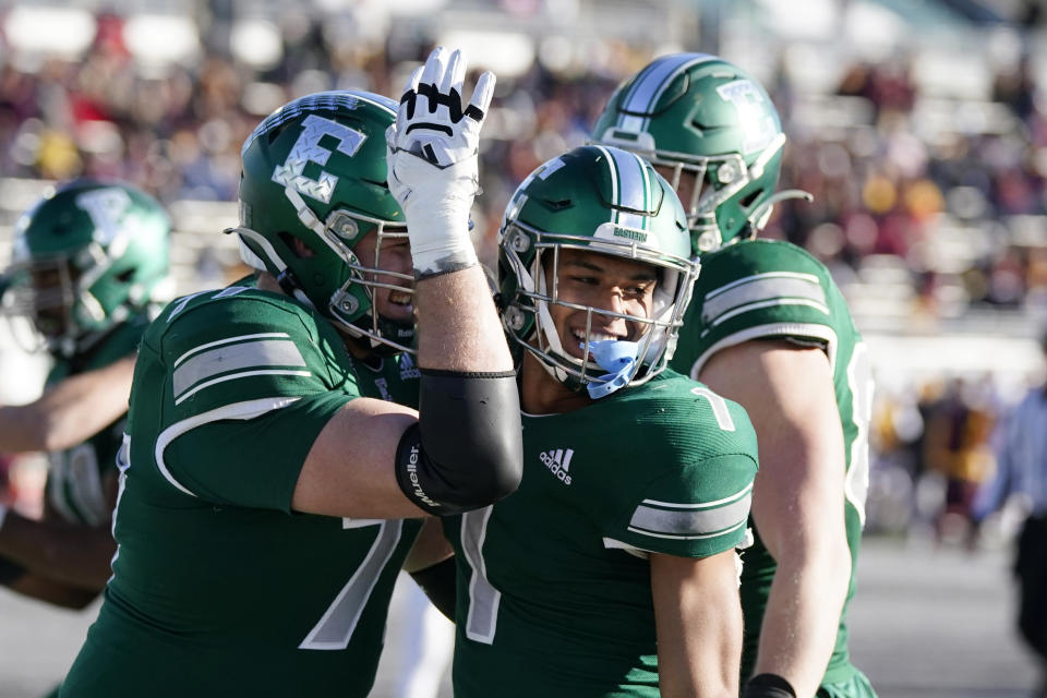 Eastern Michigan wide receiver Dylan Drummond (1) is greeted by quarterback Taylor Powell (7) after catching a pass for a touch down during the second half of an NCAA college football game against Central Michigan, Friday, Nov. 25, 2022, in Ypsilanti, Mich. (AP Photo/Carlos Osorio)