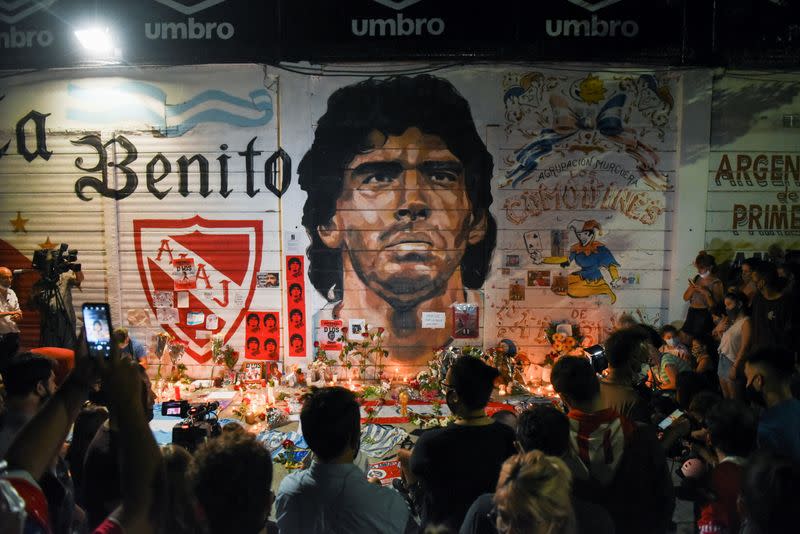 People gather to mourn the death of soccer legend Diego Maradona, outside the Diego Armando Maradona stadium, in Buenos Aires