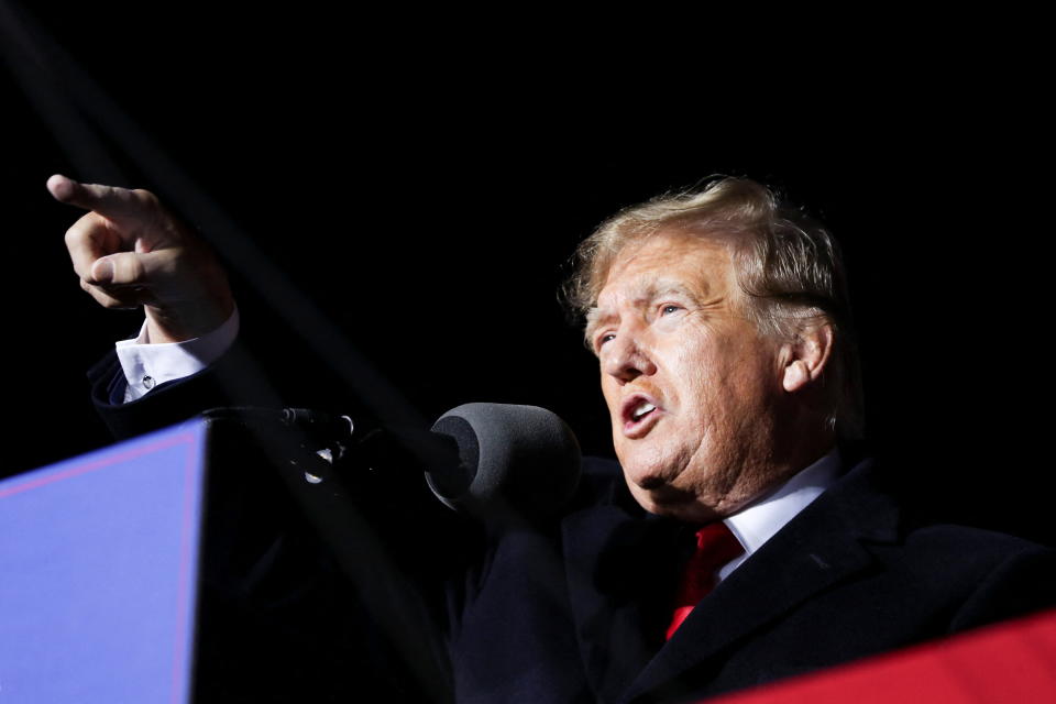 Former President Donald Trump points toward the audience as he speaks during a rally.