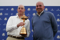 USA Captain Jim Furyk, left, and Europe Captain Thomas Bjorn pose with the trophy at the end of a news conference ahead of the Ryder Cup at the Golf National in Guyancourt, outside Paris, France, Monday, Sept. 24, 2018. The 42nd Ryder Cup Matches will be held in France from Sept. 28-30, 2018, at the Albatros Course of Le Golf National. (AP Photo/Francois Mori)