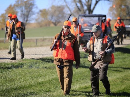 Donald Trump Jr. and Rep. Steve King talk after hunting pheasants at the Hole 'N The Wall Lodge near Akron, Iowa Saturday, Oct. 28, 2017. Trump Jr. is wearing sunglasses and is toting a shotgun on shoulder while talking with King.