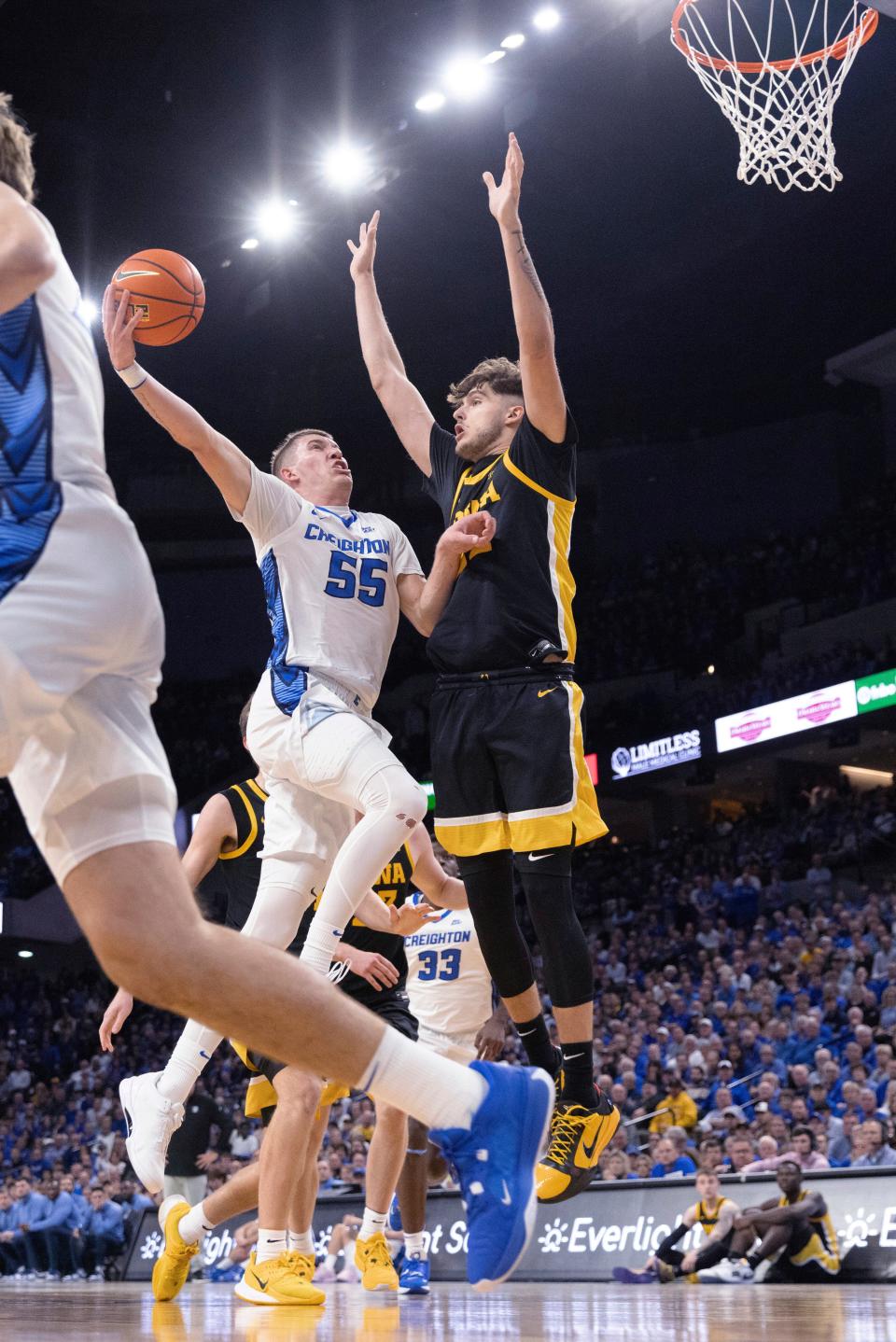 Creighton's Baylor Scheierman, left, who averages averaging 7.9 rebounds a game, drives to the basket during a nonleague game against Iowa in November.