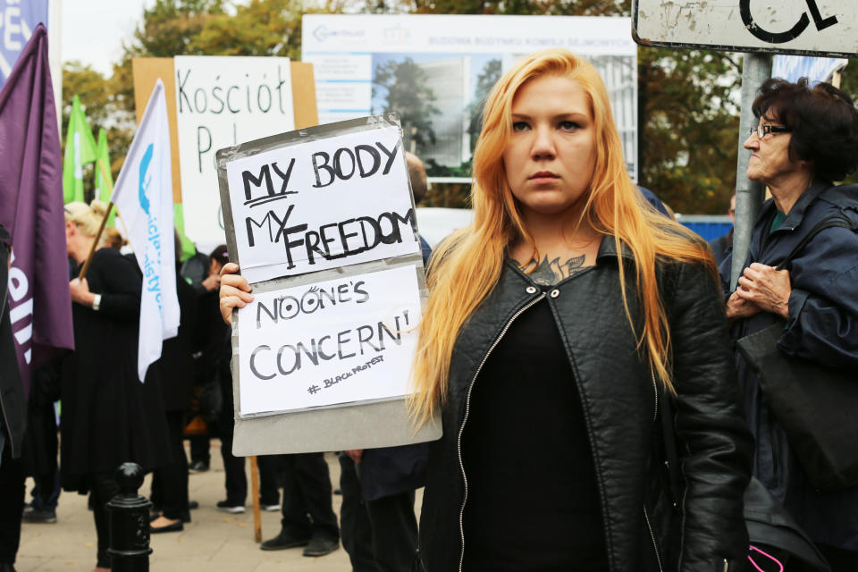 A young woman marches in Warsaw.&nbsp;