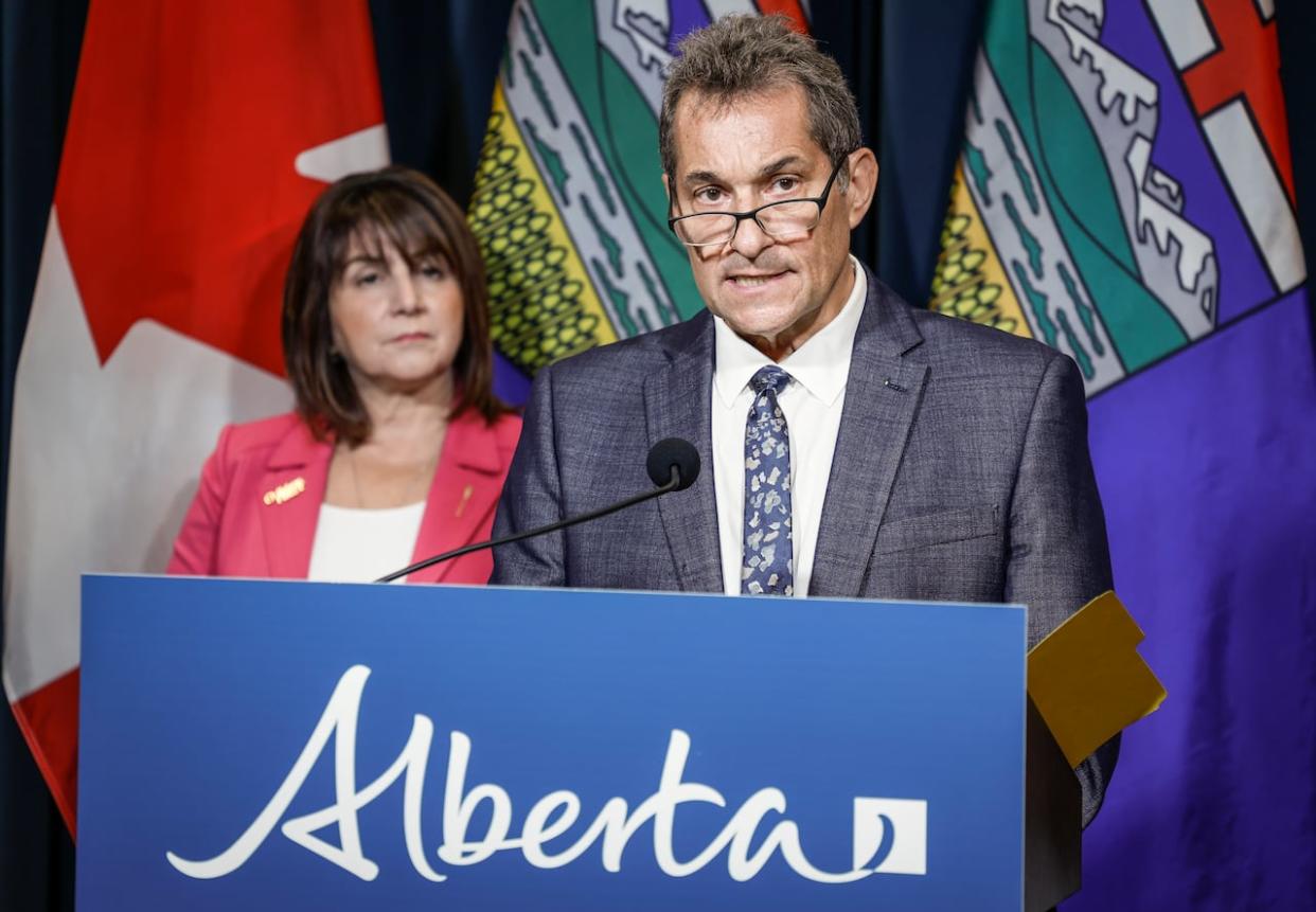 Alberta Health Minister Adriana LaGrange, left, and chief medical officer of health Dr. Mark Joffe speak to media on Tuesday, Sept. 12, about the E. coli outbreak in Calgary daycares. (Jeff McIntosh/The Canadian Press - image credit)